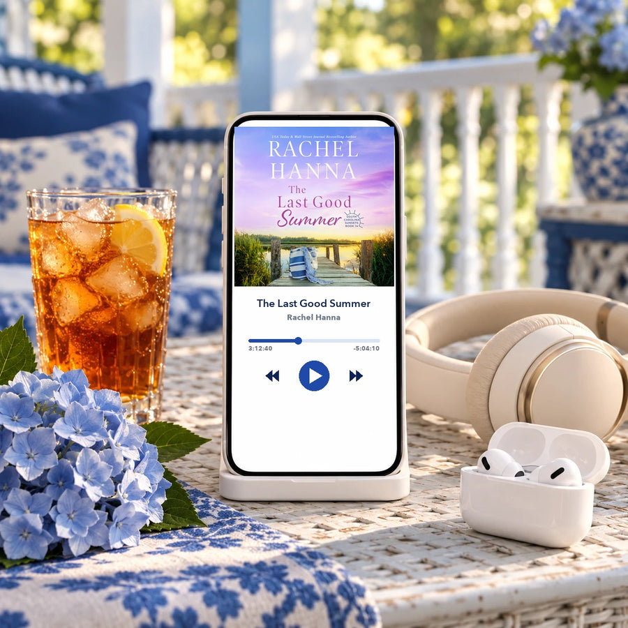 The Last Good Summer audiobook by Rachel Hanna on a phone, with headphones and sweet tea on a porch table